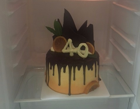 Finished chocolate orange flourless drip cake with a number 40 to celebrate a birthday
