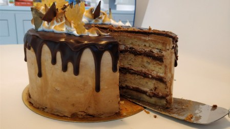 slicing the chocolate banana drip cake