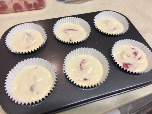 Cupcake batter with raspberry and white chocolate chips