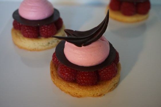 The finished raspberries tart, decorated with a chocolate leaf